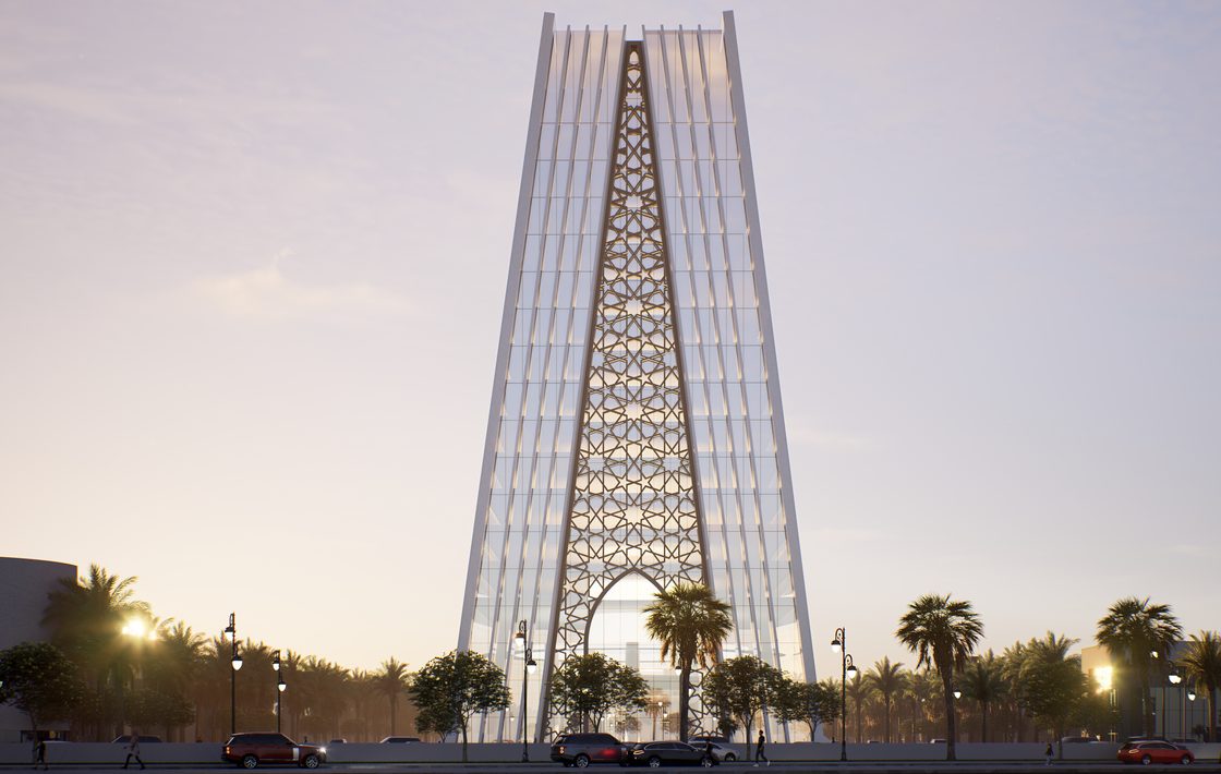 Evening view of the pointed-arch entrance at the base of the tower.