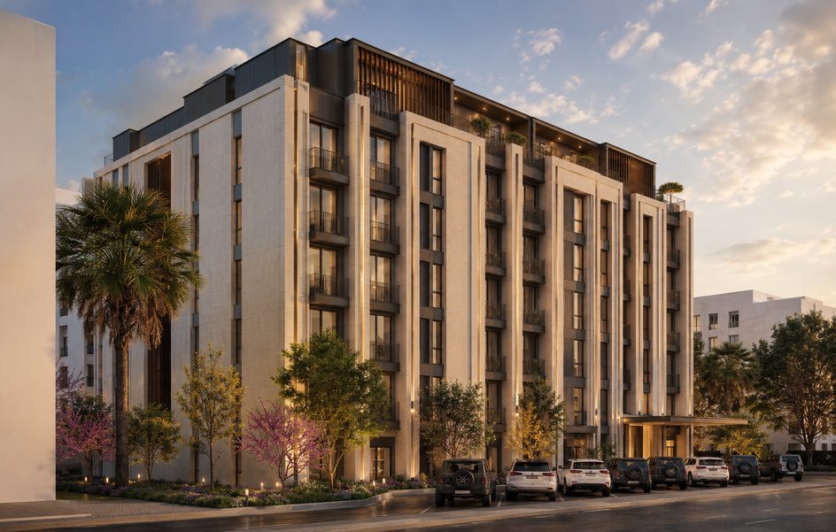 Street-corner view of the residential building at dusk.