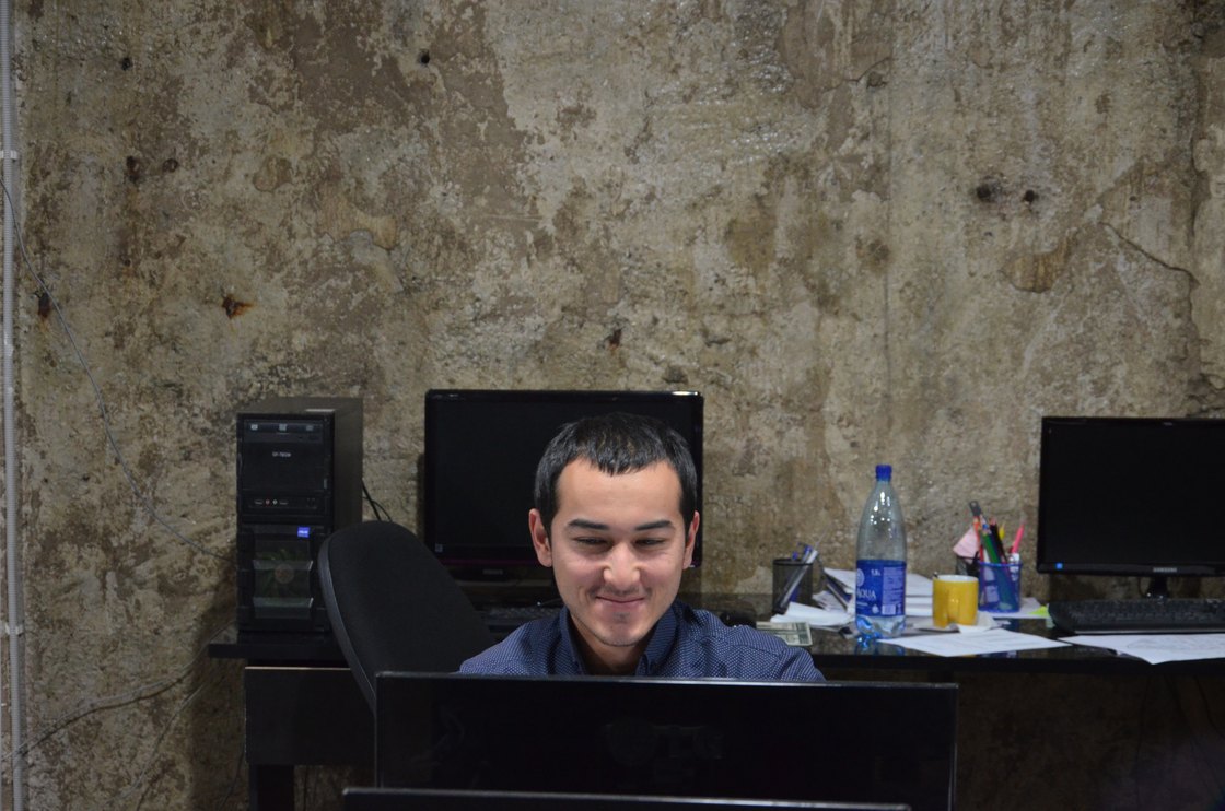 At a desk in the studio